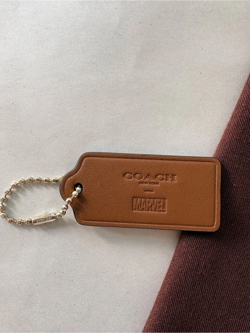 🦸♀️ Coach x MARVEL Ltd Ed Saddle Brown Leather HangTag Bag Charm | 2.375” - Picture 5 of 7